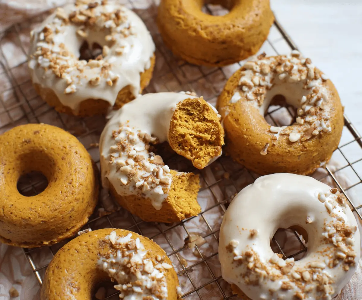 Freshly baked pumpkin donuts with cinnamon and sugar topping on a rustic plate, perfect for fall treats