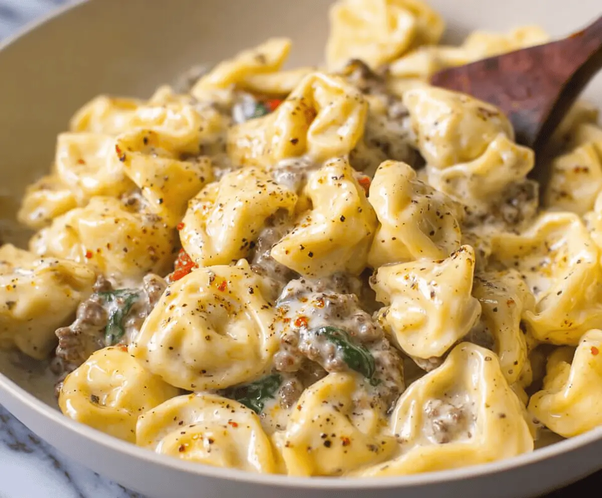 Delicious garlic butter beef and spinach tortellini dish served on a plate with fresh herbs