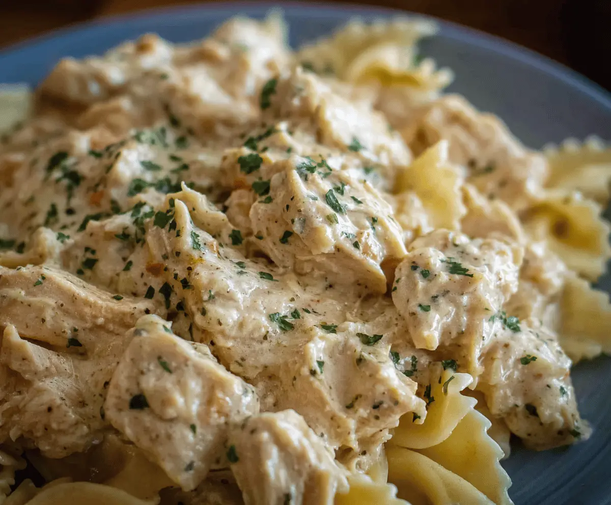 Creamy Ranch Chicken cooked in a crockpot, featuring tender chicken breasts coated with flavorful ranch seasoning and creamy sauce, served as a delicious comfort meal.
