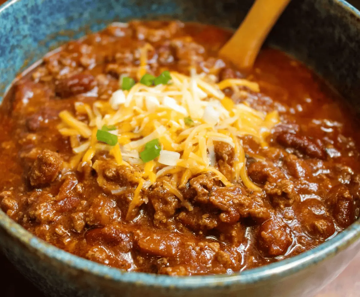 Delicious homemade Pioneer Woman chili in a bowl topped with shredded cheese and fresh herbs, perfect for a comforting family meal.