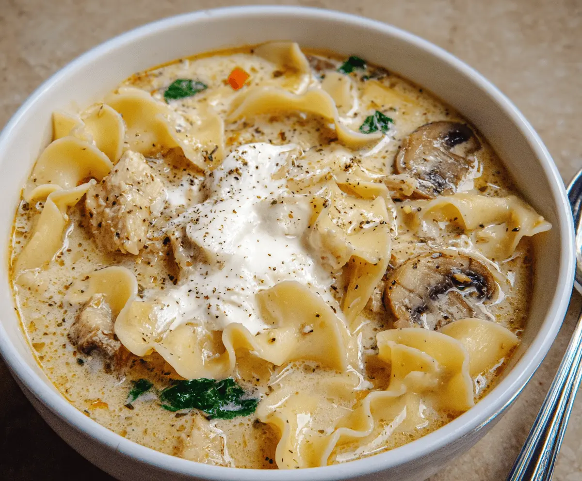 Creamy White Lasagna Soup with ricotta, spinach, and shredded cheese in a bowl, garnished with herbs