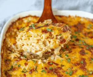 Delicious French Onion Chicken Orzo Casserole topped with melted cheese and caramelized onions in a baking dish