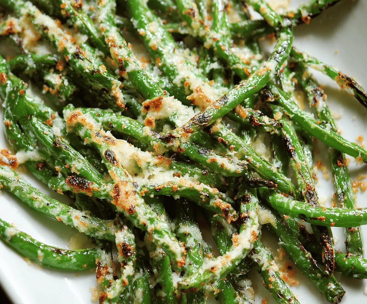 Golden roasted green beans topped with grated Parmesan cheese, served as a delicious side dish