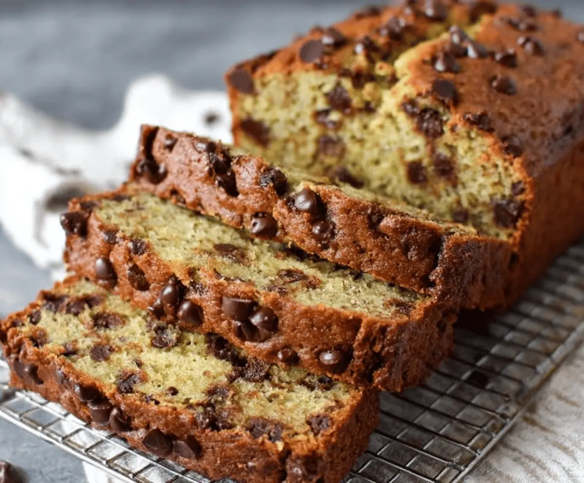 Delicious super moist chocolate chip banana bread with ripe bananas and melted chocolate chips, perfect for a sweet snack or breakfast