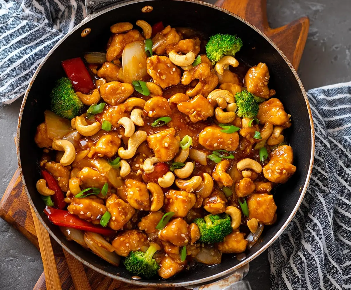 Delicious homemade Cashew Chicken with tender chicken pieces and crunchy cashews on a colorful plate.