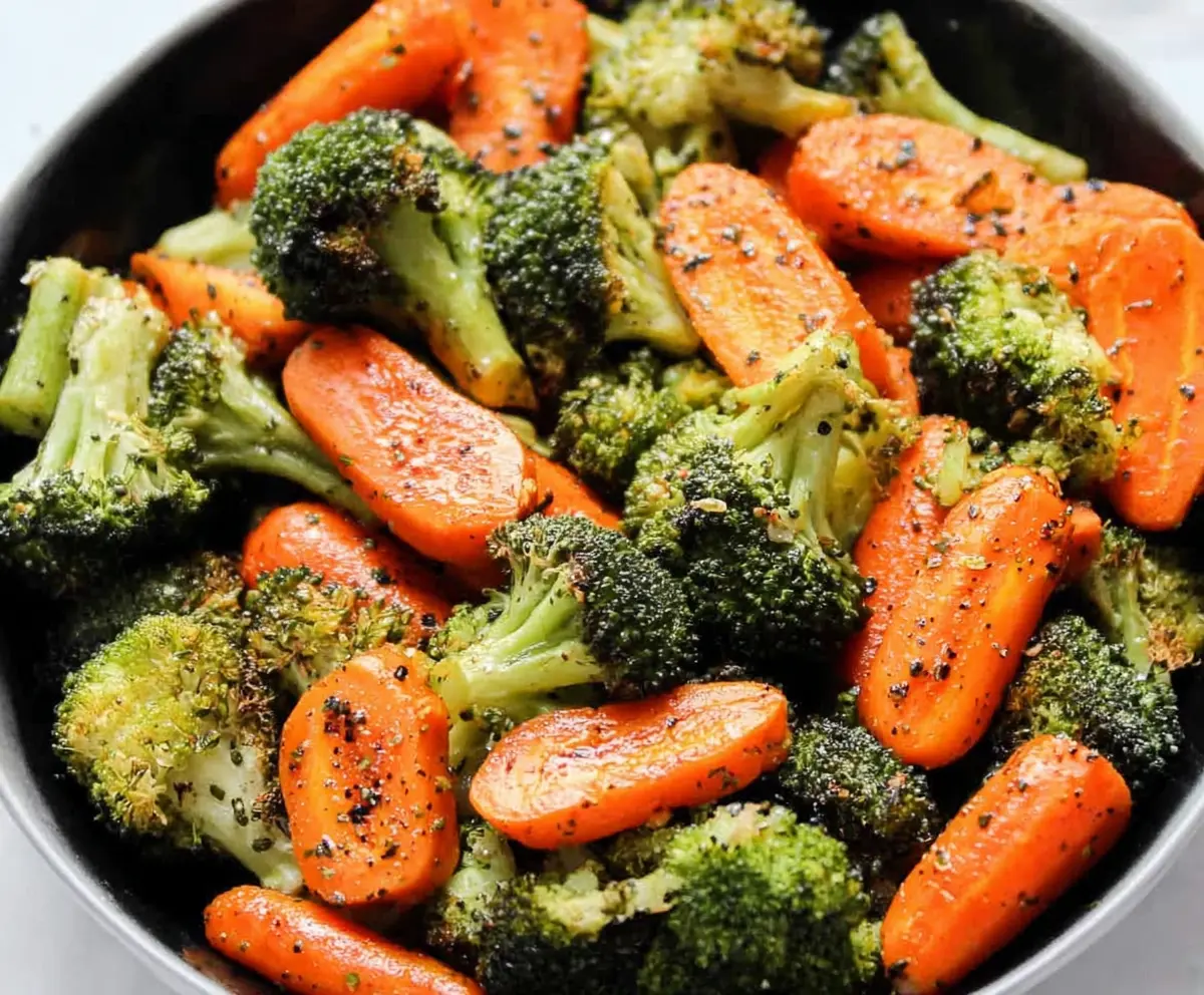 Delicious roasted broccoli and carrots on a plate, perfect for healthy eating.